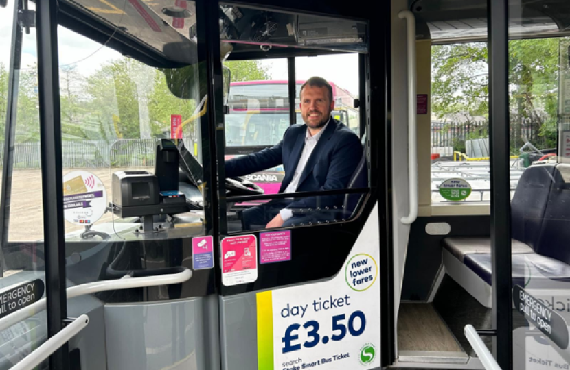 Jonathan sitting behind the wheel of a bus