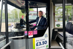 Jonathan sitting behind the wheel of a bus