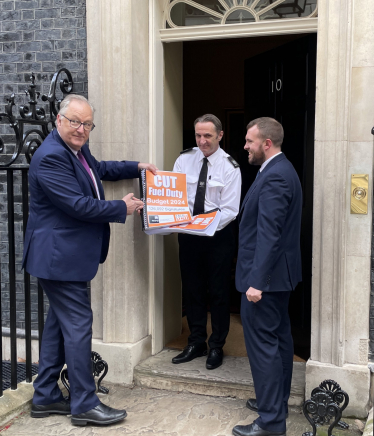 Jonathan Gullis outside 10 Downing Street holding a petition